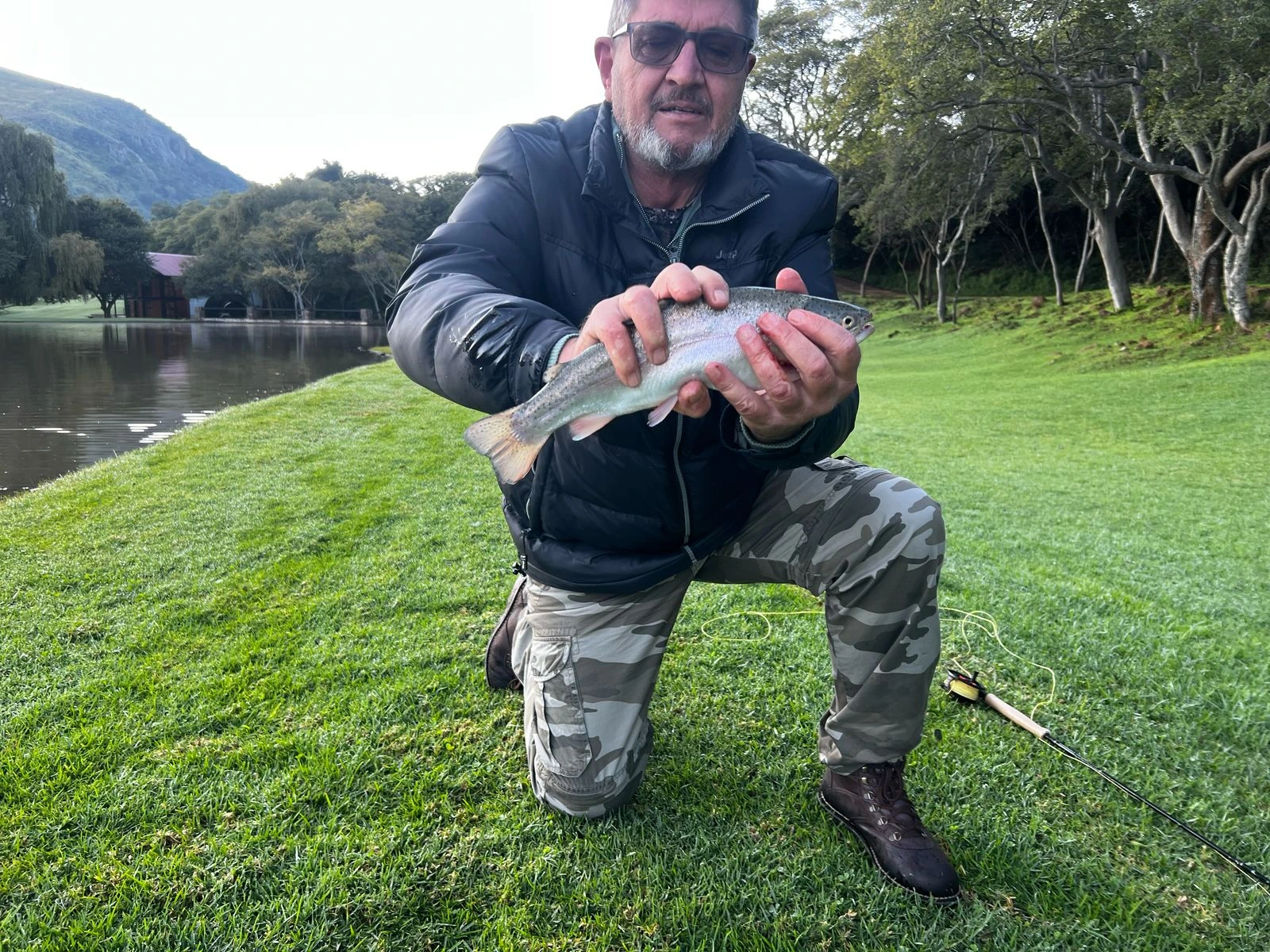 Angler with a rainbow trout landed at Valley of the Rainbow